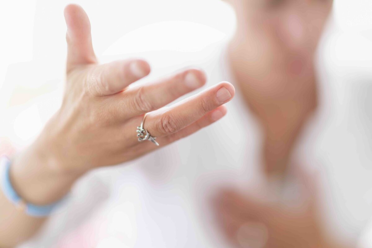 close of hand of woman practicing relaxing techniques