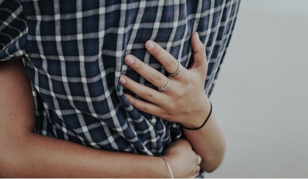 close up of a man being hugged