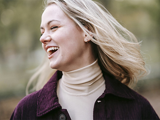 Woman feeling happy and laughing after a anxiety therapy session.