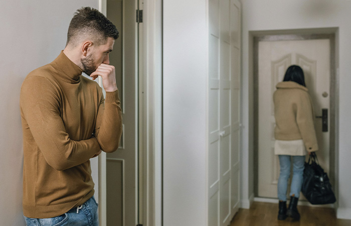 Woman leaving her partner, represents how you can recognize the signs of a toxic relationship and choose to walk away.