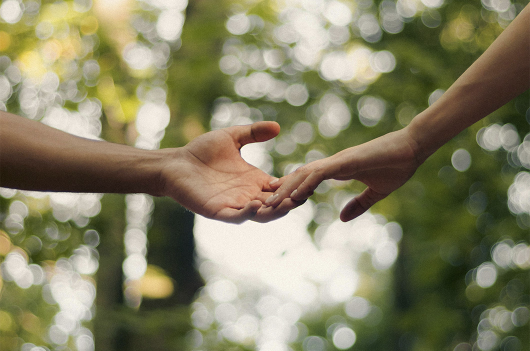 Two hands reaching toward each other, represents the journey of how our therapist Jessica Krock became a counselor.