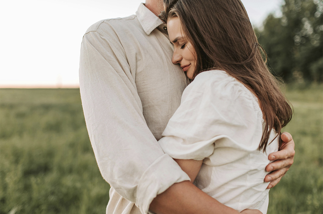 Couple embracing each other at sunset, represents how the Gottman Trust Revival Method can help heal from an affair.